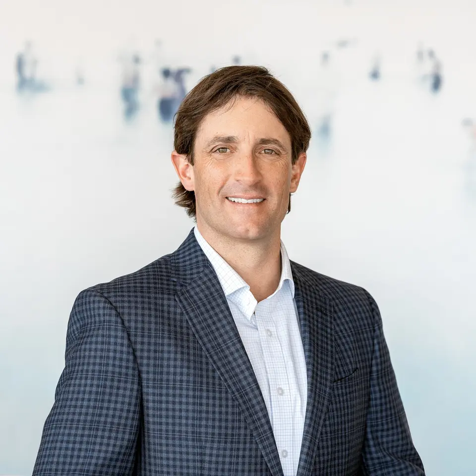 Patrick Barrett, Vail and Beaver Creek real estate broker, in a checked suit jacket and light blue shirt