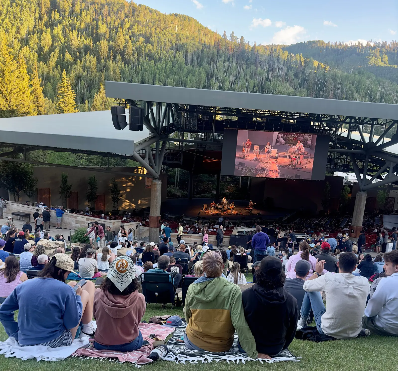 Audience on the lawn at an outdoor amphitheater concert in Vail