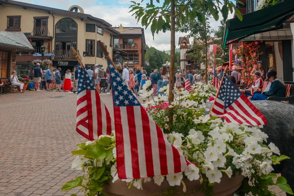 Small American flags in a flower planter along a Vail Village street