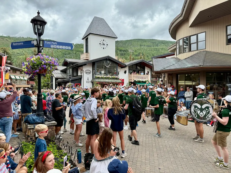 Marching band playing past the Vail Village clock tower during the parade