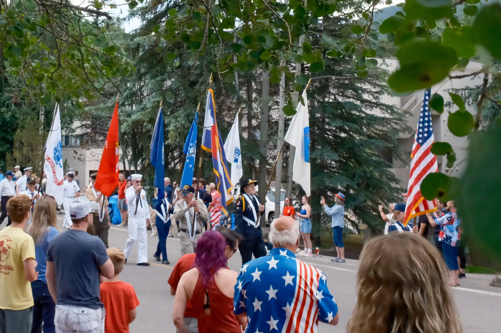 Flag bearers and spectators at a Fourth of July parade